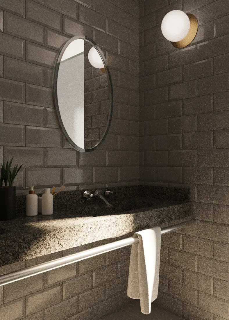 Bathroom detail with a round mirror, textured masonry wall, stone counter, and warm light.